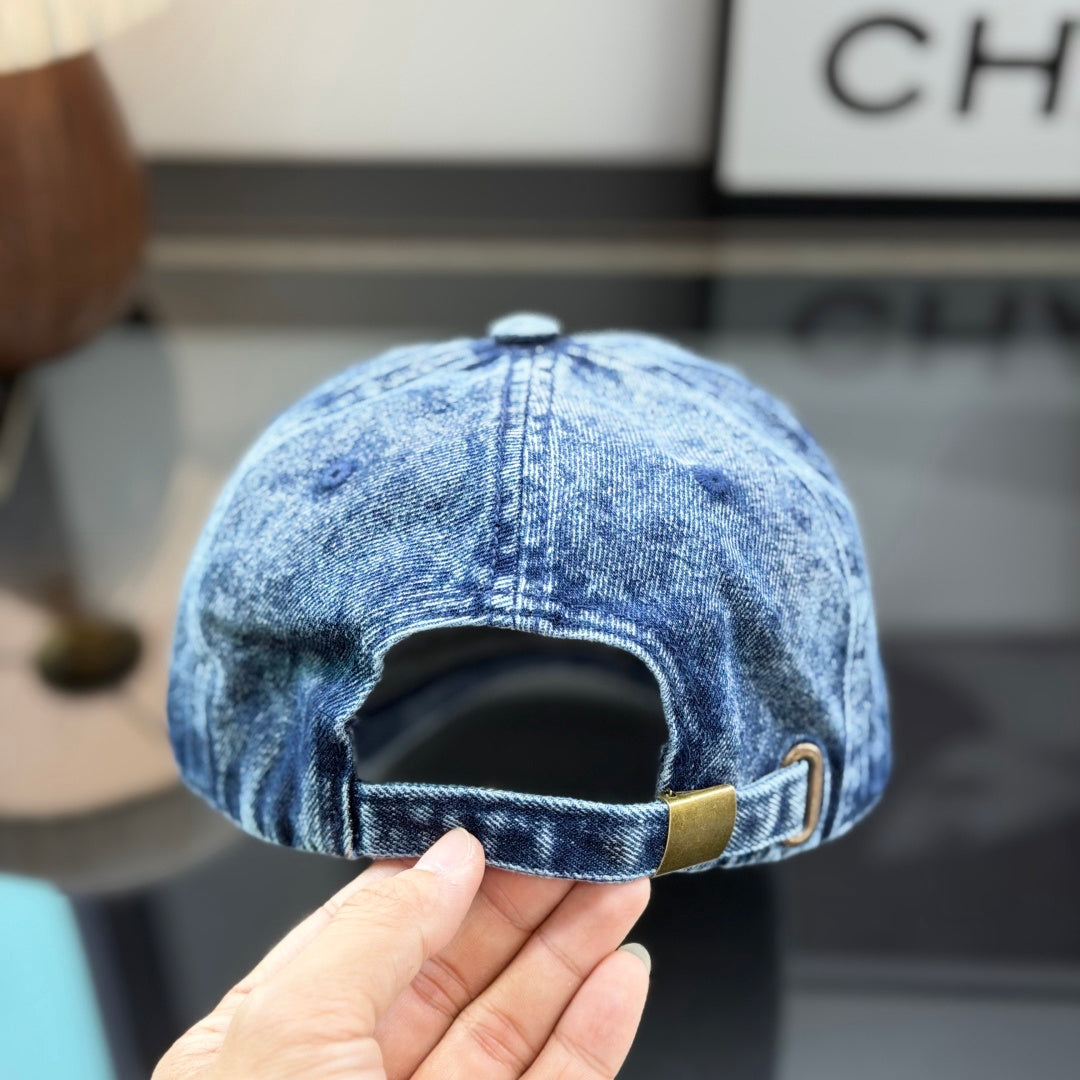 A vintage acid-washed denim baseball cap with embroidered logo detail, styled for a casual look.