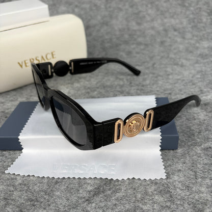 Classic black rectangular frame sunglasses featuring decorative gold-tone metallic side accents.