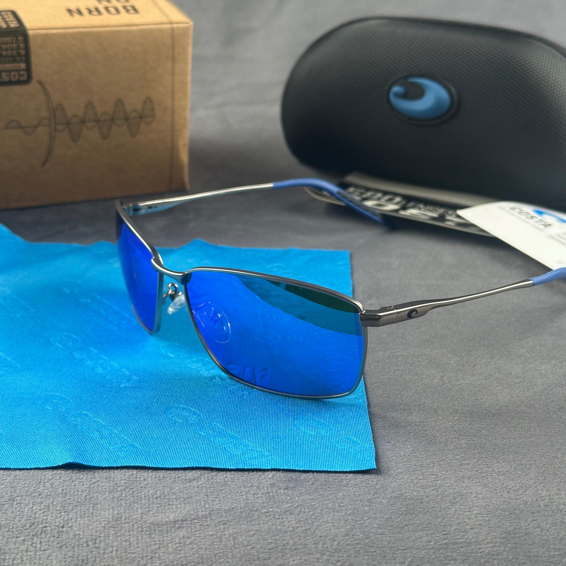 Close-up of performance polarized sunglasses with blue mirror lenses and lightweight metal frame.