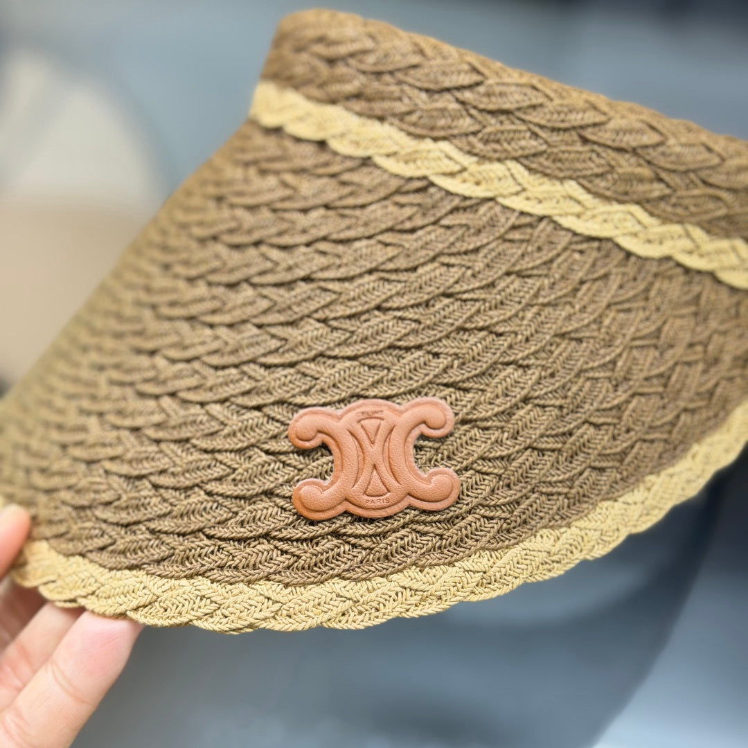 A stylish, high-quality woven straw visor hat with a decorative emblem, perfect for summer sun prote