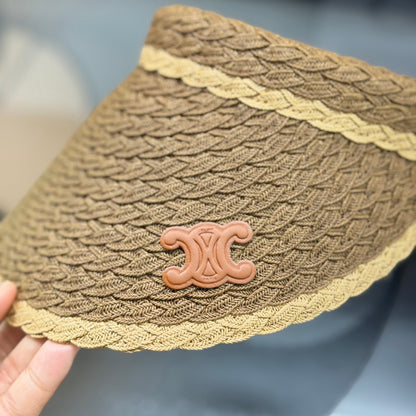 A stylish, high-quality woven straw visor hat with a decorative emblem, perfect for summer sun prote