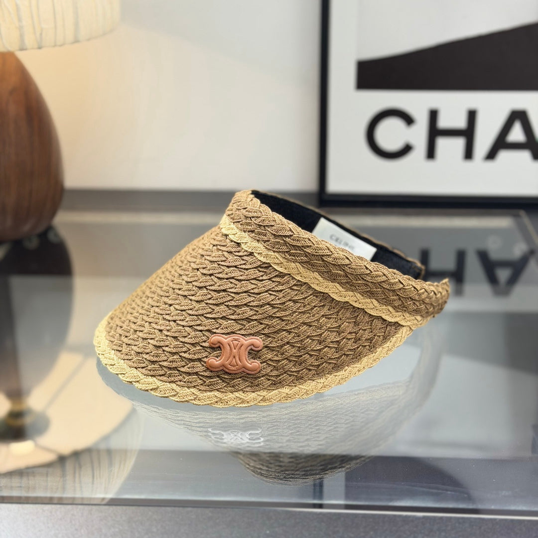 A stylish, high-quality woven straw visor hat with a decorative emblem, perfect for summer sun prote