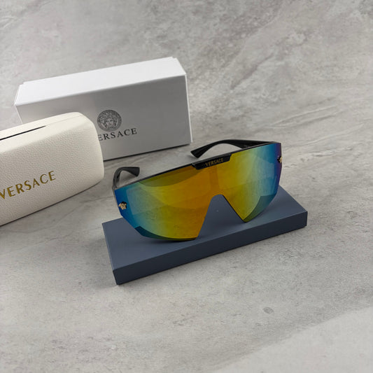 Modern shield-style visor sunglasses with wide black frames and vibrant gradient mirror lenses.