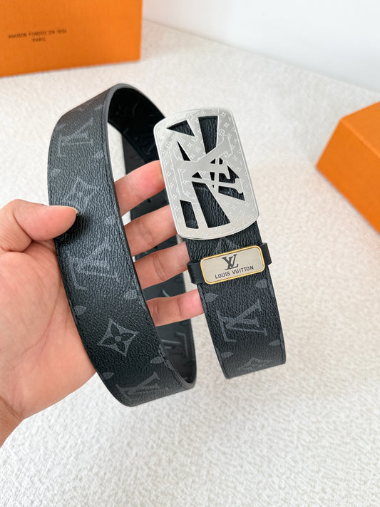 A black leather belt with monogram pattern and an intricate silver-tone buckle, 3.8cm wide.