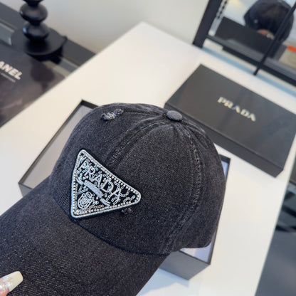 A black distressed denim baseball cap with a sparkling triangular patch on the front center.