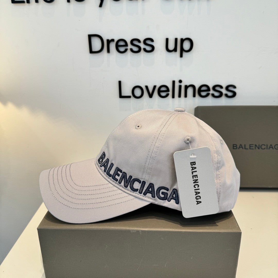 A grey cotton baseball cap with embroidered lettering, featuring a curved brim and adjustable back.