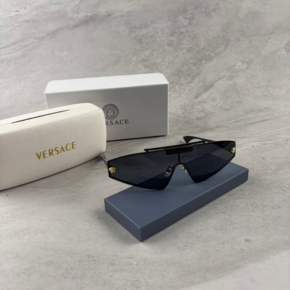 Modern shield sunglasses with a sleek black frame and dark tinted lenses on a grey background.