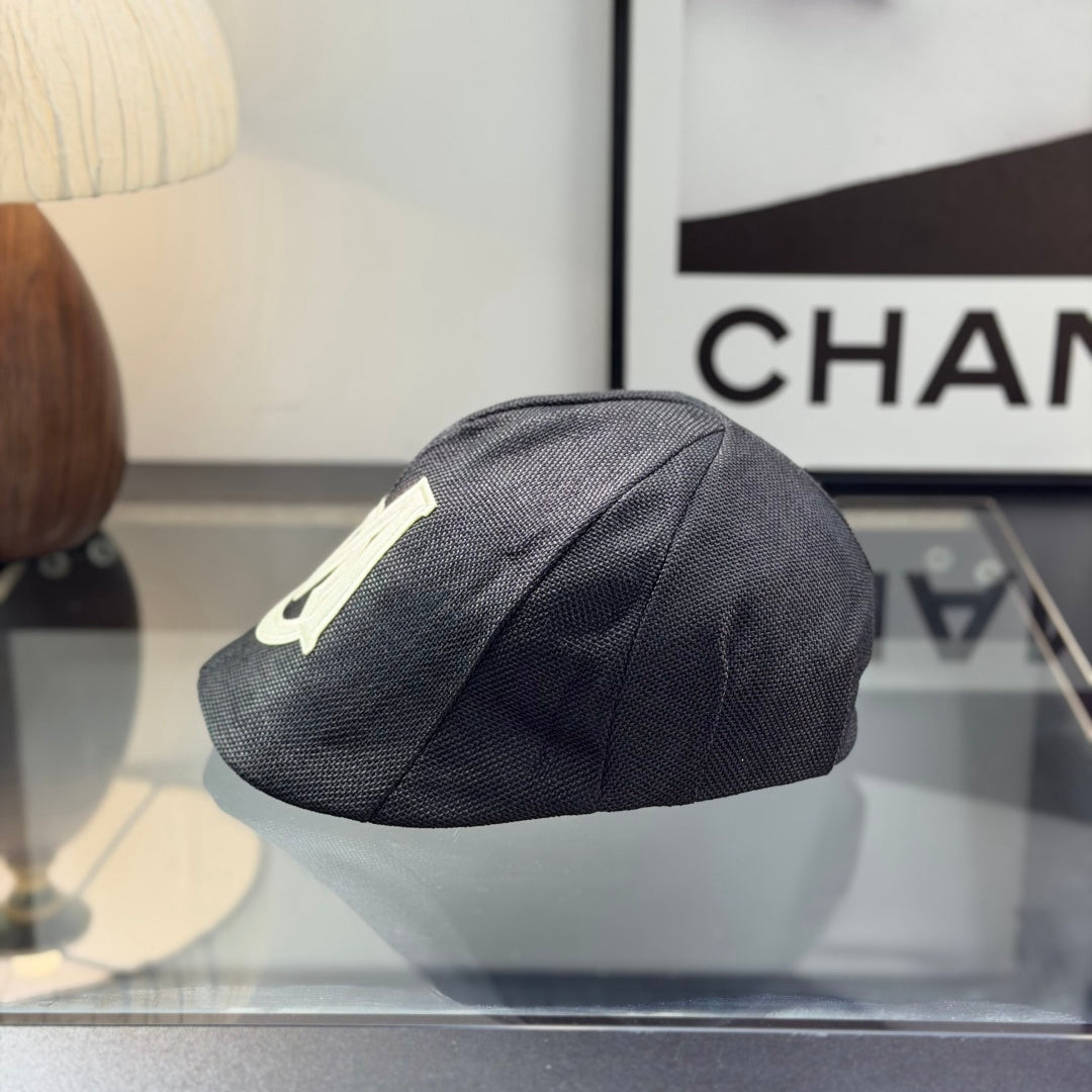 Close-up of a premium dark grey textured ivy cap with a white embroidered logo, high-quality fabric.