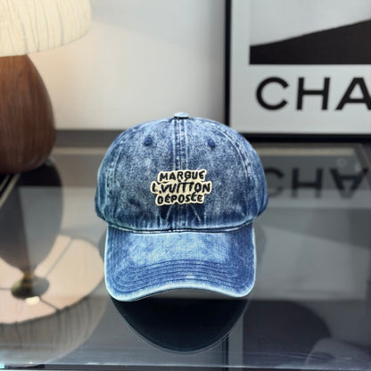 A vintage acid-washed denim baseball cap with embroidered logo detail, styled for a casual look.