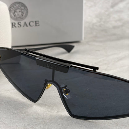 Modern shield sunglasses with a sleek black frame and dark tinted lenses on a grey background.