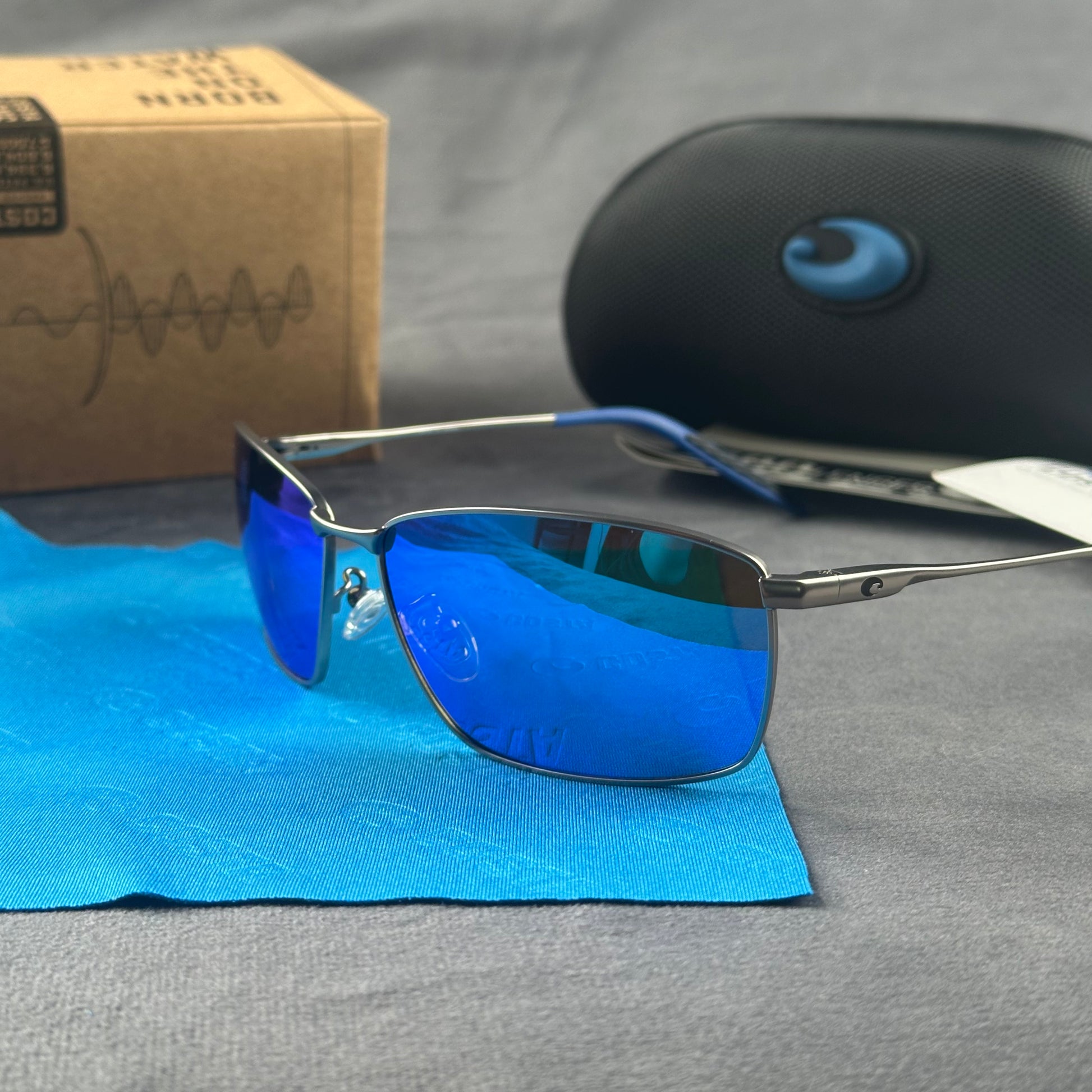 Close-up of performance polarized sunglasses with blue mirror lenses and lightweight metal frame.