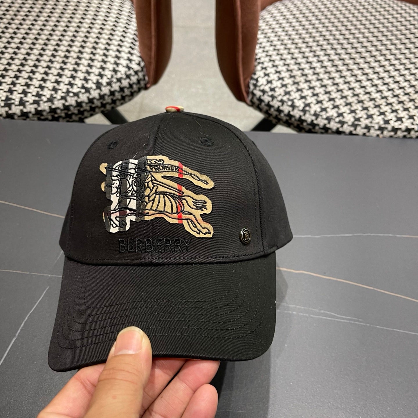 Black cotton baseball cap with intricate equestrian embroidery and a subtle metallic side accent.