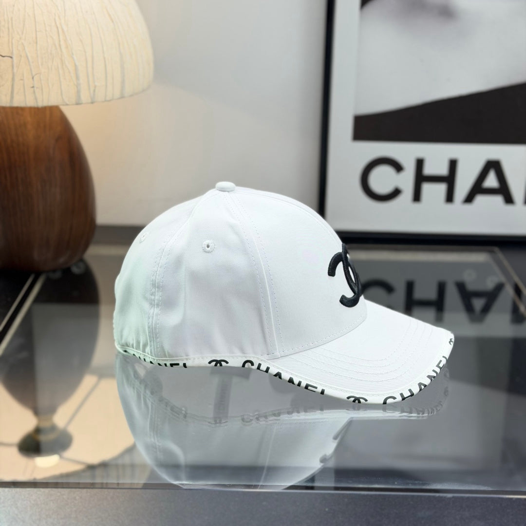 A white premium baseball cap with black embroidered logo details on a clean display surface.