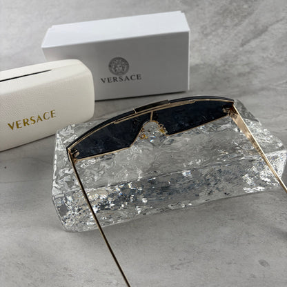 Gold metal frame shield sunglasses with dark lenses, featuring elegant temple detailing.