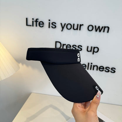 Close up of a black athletic sun visor with an adjustable strap, lightweight and breathable fabric.
