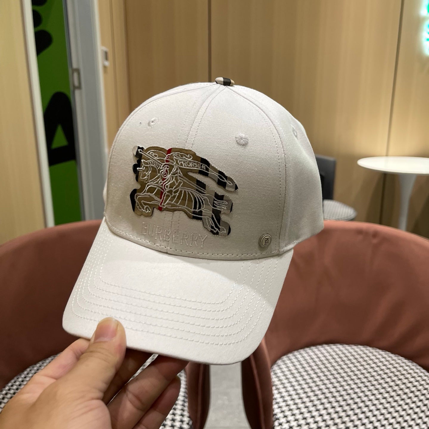 A white structured cotton baseball cap featuring an intricate equestrian embroidery patch on front.