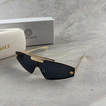 Gold metal frame shield sunglasses with dark lenses, featuring elegant temple detailing.