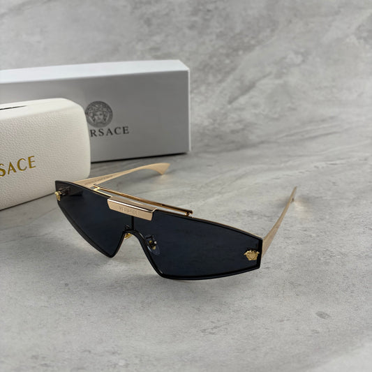 Gold metal frame shield sunglasses with dark lenses, featuring elegant temple detailing.