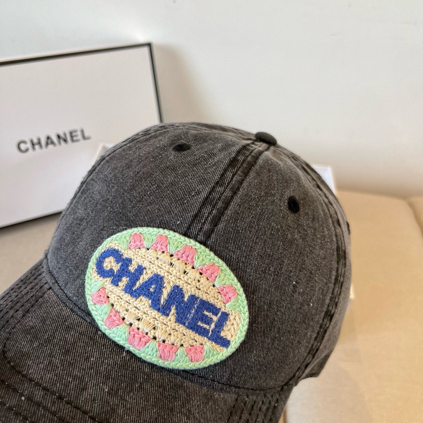 Black vintage-washed denim baseball cap featuring a colorful embroidered circular front patch.