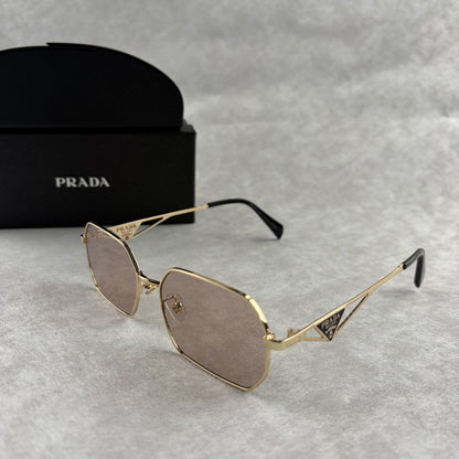 A pair of stylish geometric sunglasses featuring thin gold metal frames and tinted lenses.