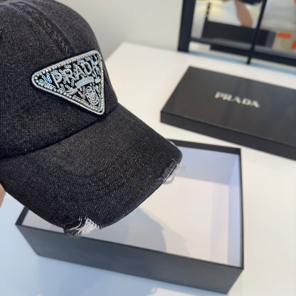 A black distressed denim baseball cap with a sparkling triangular patch on the front center.