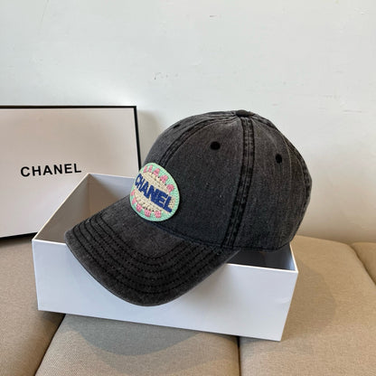 Black vintage-washed denim baseball cap featuring a colorful embroidered circular front patch.