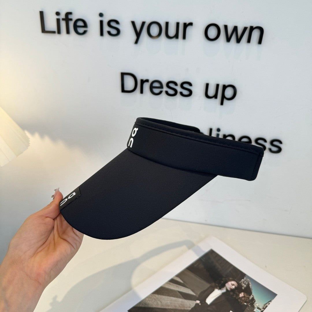 Close up of a black athletic sun visor with an adjustable strap, lightweight and breathable fabric.