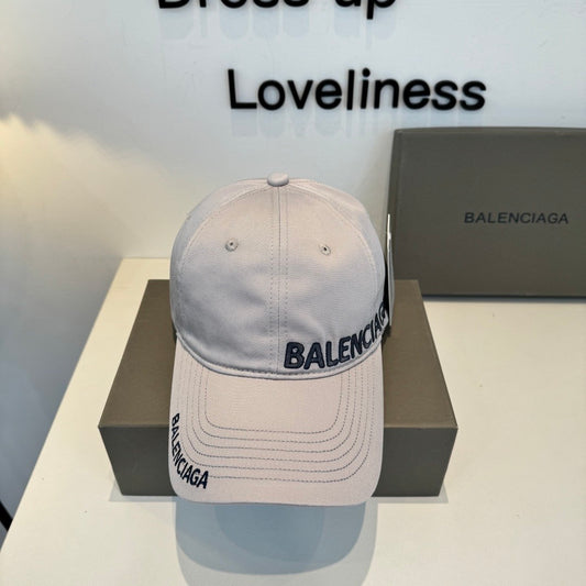 A grey cotton baseball cap with embroidered lettering, featuring a curved brim and adjustable back.