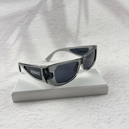 Modern rectangular sunglasses in translucent gray with dark tinted lenses, includes protective case.