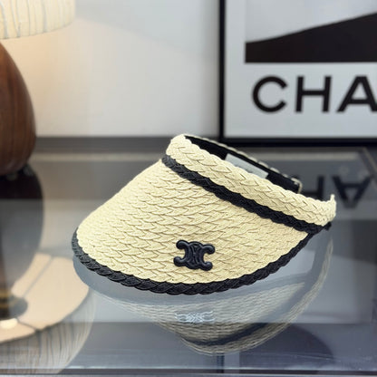 Woven straw sun visor with black contrast trim and decorative logo detail for summer protection.