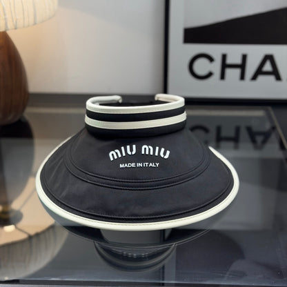 A black sun visor with white contrast trim, featuring an open-top design for breathability and sun p