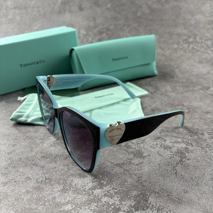 Stylish cat-eye sunglasses with gradient lenses and heart-shaped silver side details.