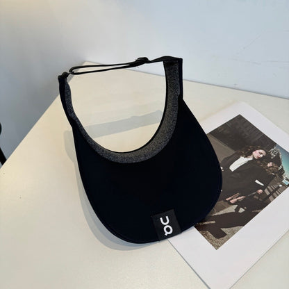 Close up of a black athletic sun visor with an adjustable strap, lightweight and breathable fabric.