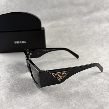 Modern black rectangular sunglasses with dark lenses and thick frame, isolated on a light background