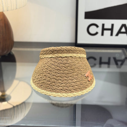 A stylish, high-quality woven straw visor hat with a decorative emblem, perfect for summer sun prote