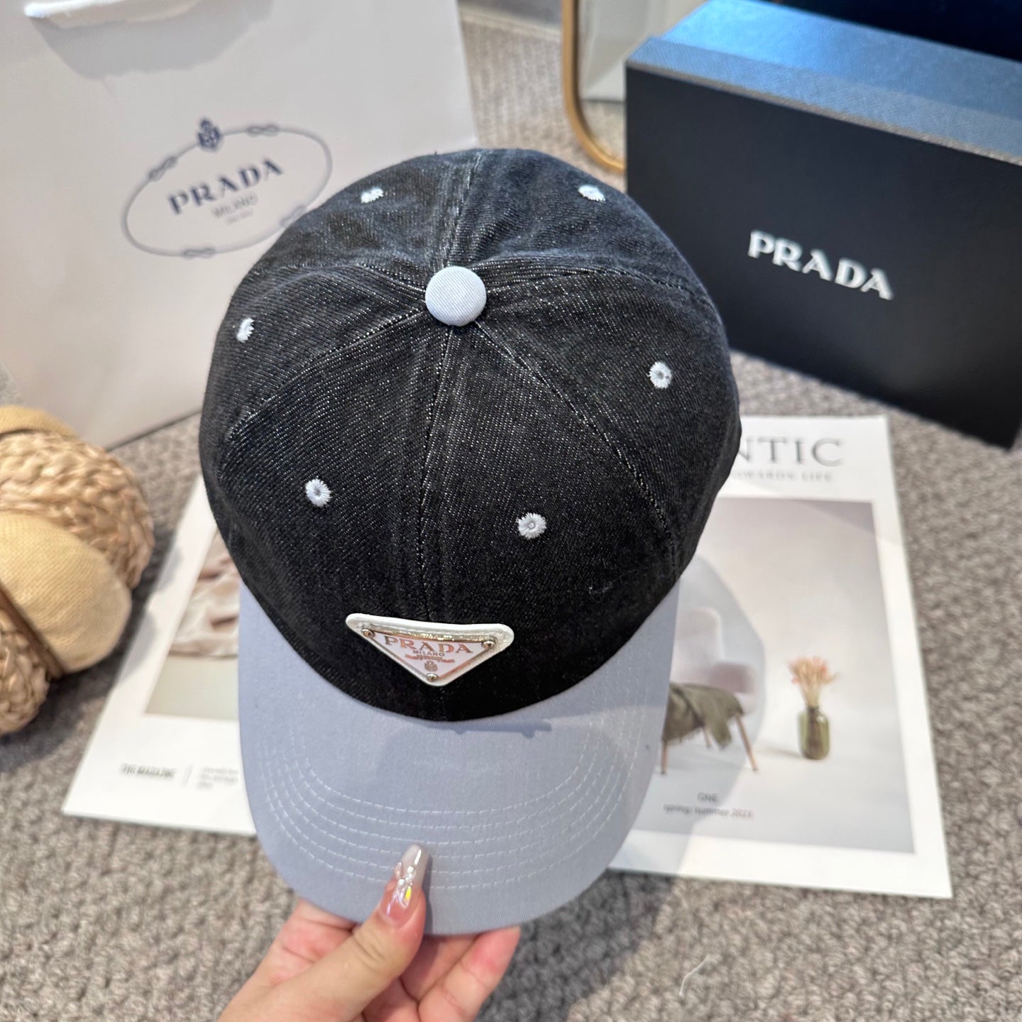 A two-tone denim baseball cap featuring a white triangle emblem patch on the front, neutral brim.