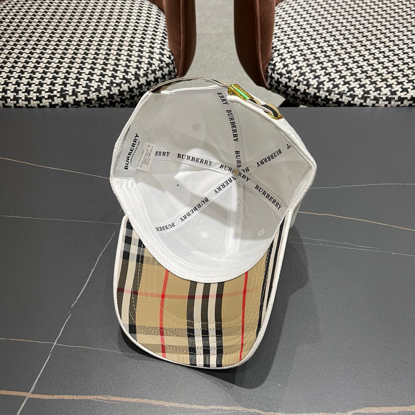 A white structured cotton baseball cap featuring an intricate equestrian embroidery patch on front.
