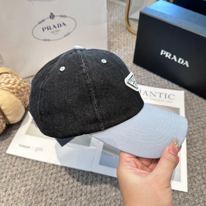 A two-tone denim baseball cap featuring a white triangle emblem patch on the front, neutral brim.