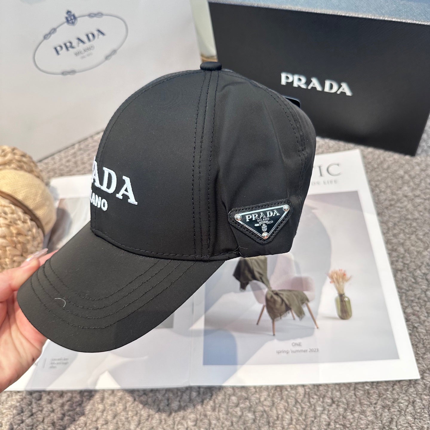 Black nylon baseball cap with white embroidered lettering and side metal logo plaque.