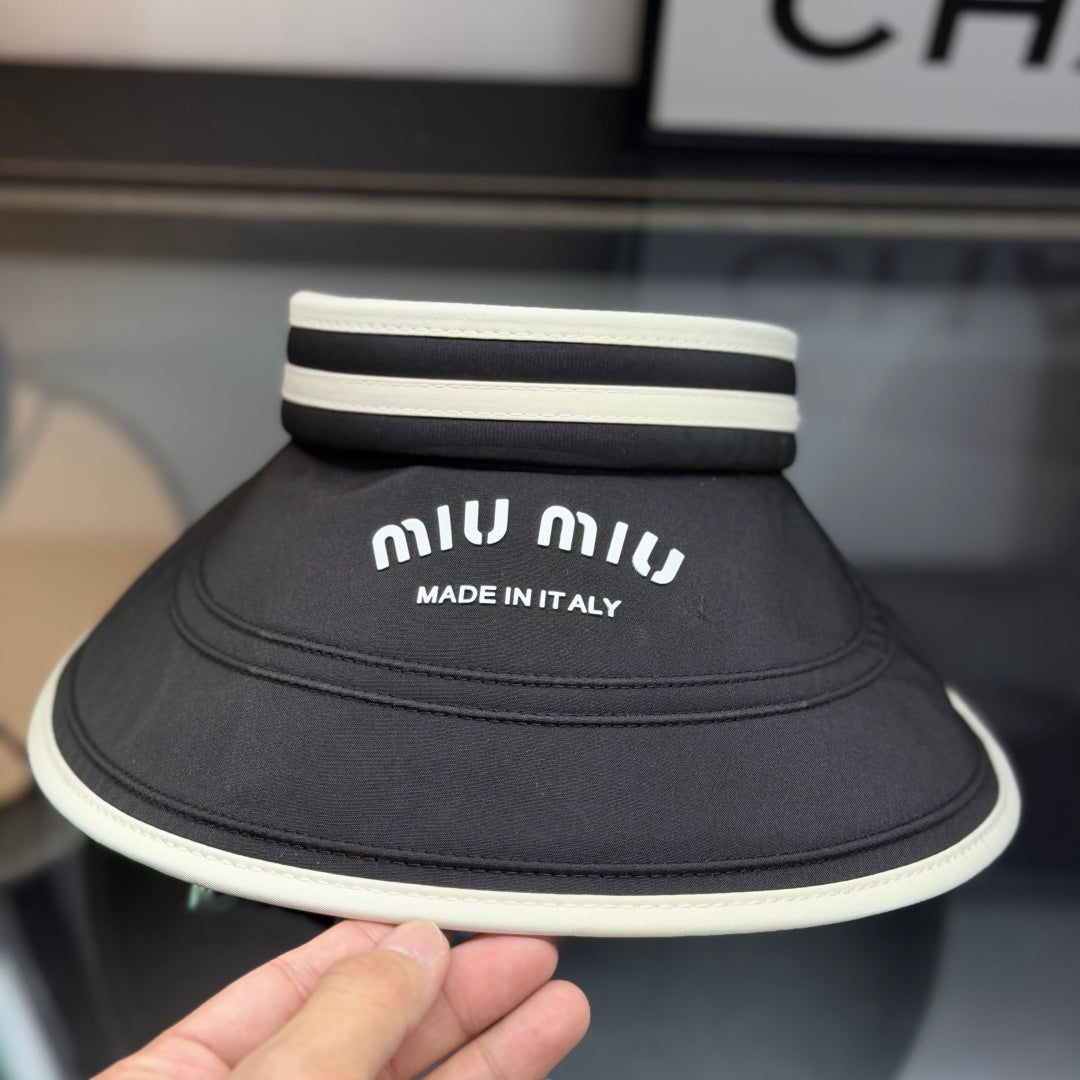 A black sun visor with white contrast trim, featuring an open-top design for breathability and sun p