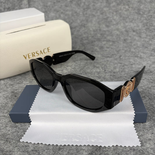 Classic black rectangular frame sunglasses featuring decorative gold-tone metallic side accents.
