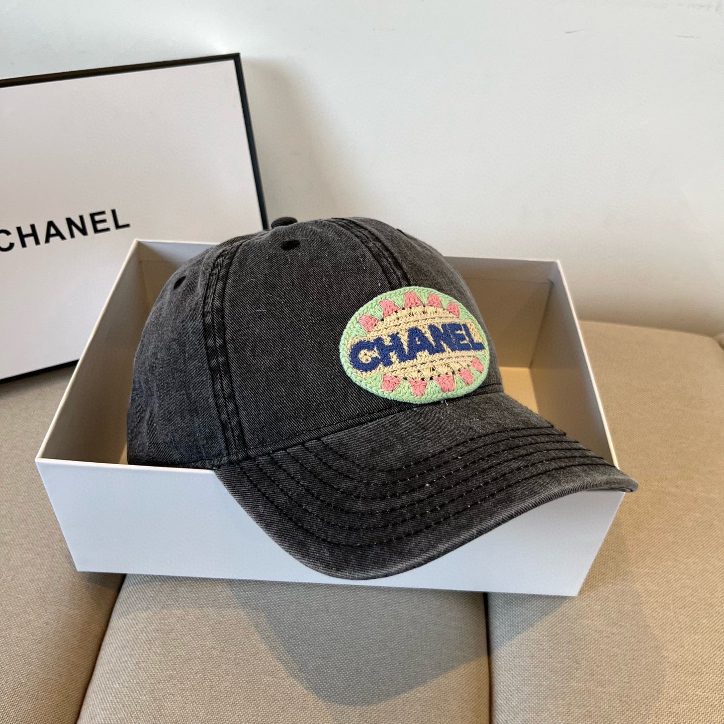 Black vintage-washed denim baseball cap featuring a colorful embroidered circular front patch.