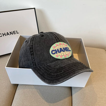 Black vintage-washed denim baseball cap featuring a colorful embroidered circular front patch.