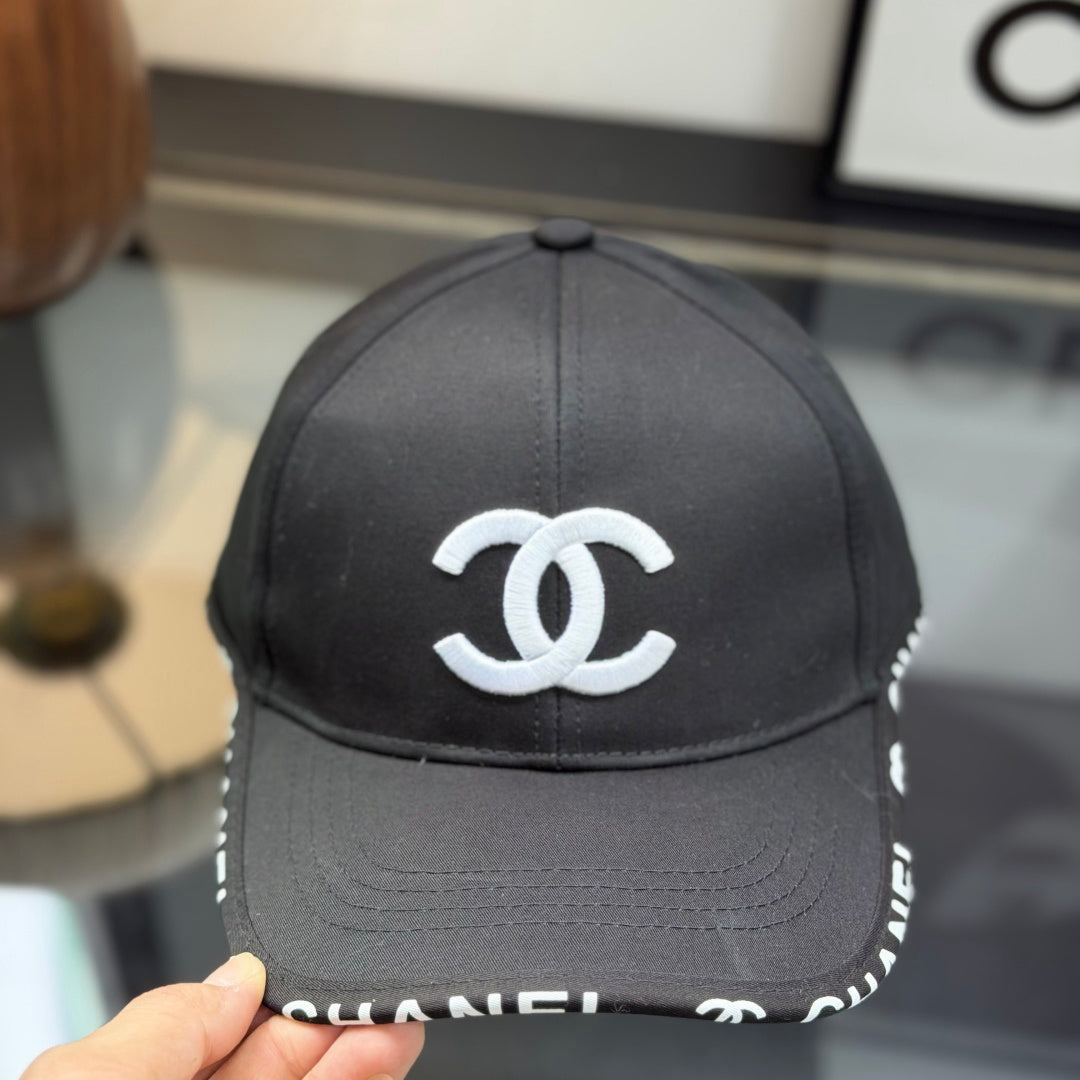 A classic black baseball cap featuring white embroidered logo, sturdy cotton blend, adjustable strap