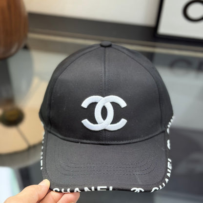 A classic black baseball cap featuring white embroidered logo, sturdy cotton blend, adjustable strap