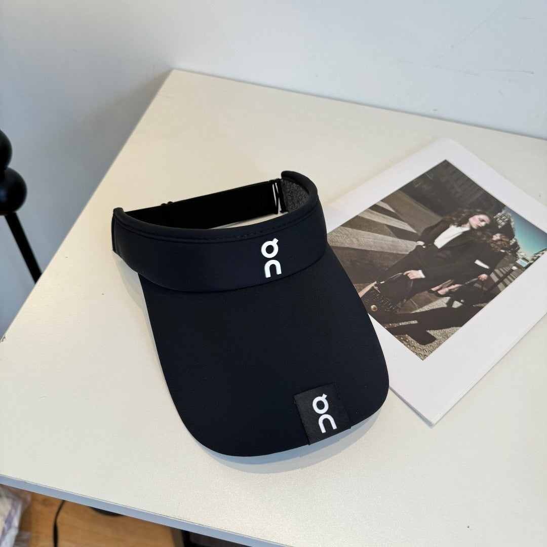 Close up of a black athletic sun visor with an adjustable strap, lightweight and breathable fabric.