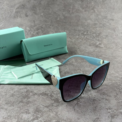 Stylish cat-eye sunglasses with gradient lenses and heart-shaped silver side details.