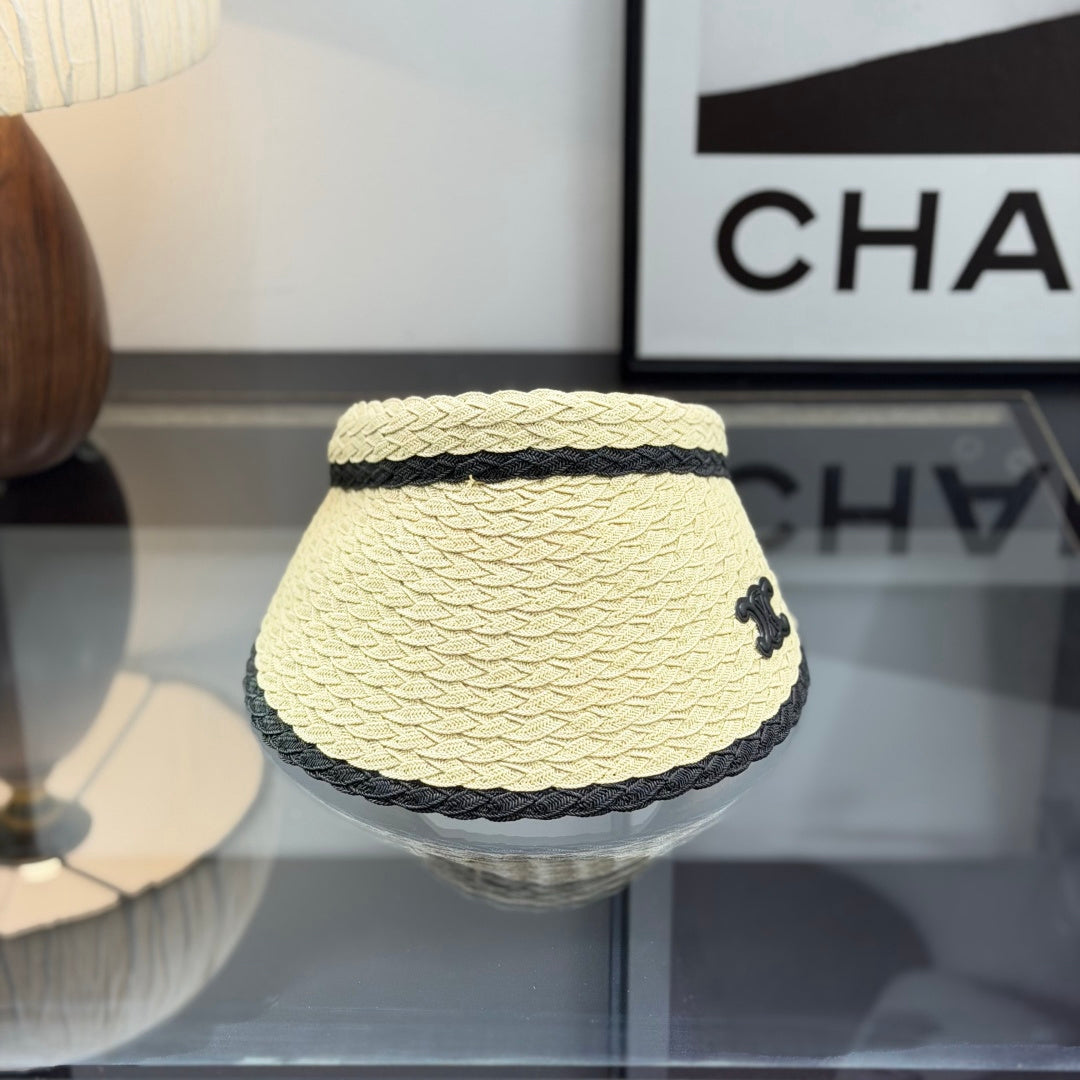 Woven straw sun visor with black contrast trim and decorative logo detail for summer protection.