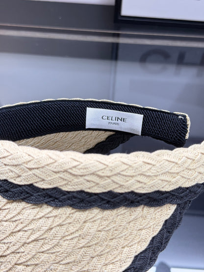 Woven straw sun visor with black contrast trim and decorative logo detail for summer protection.