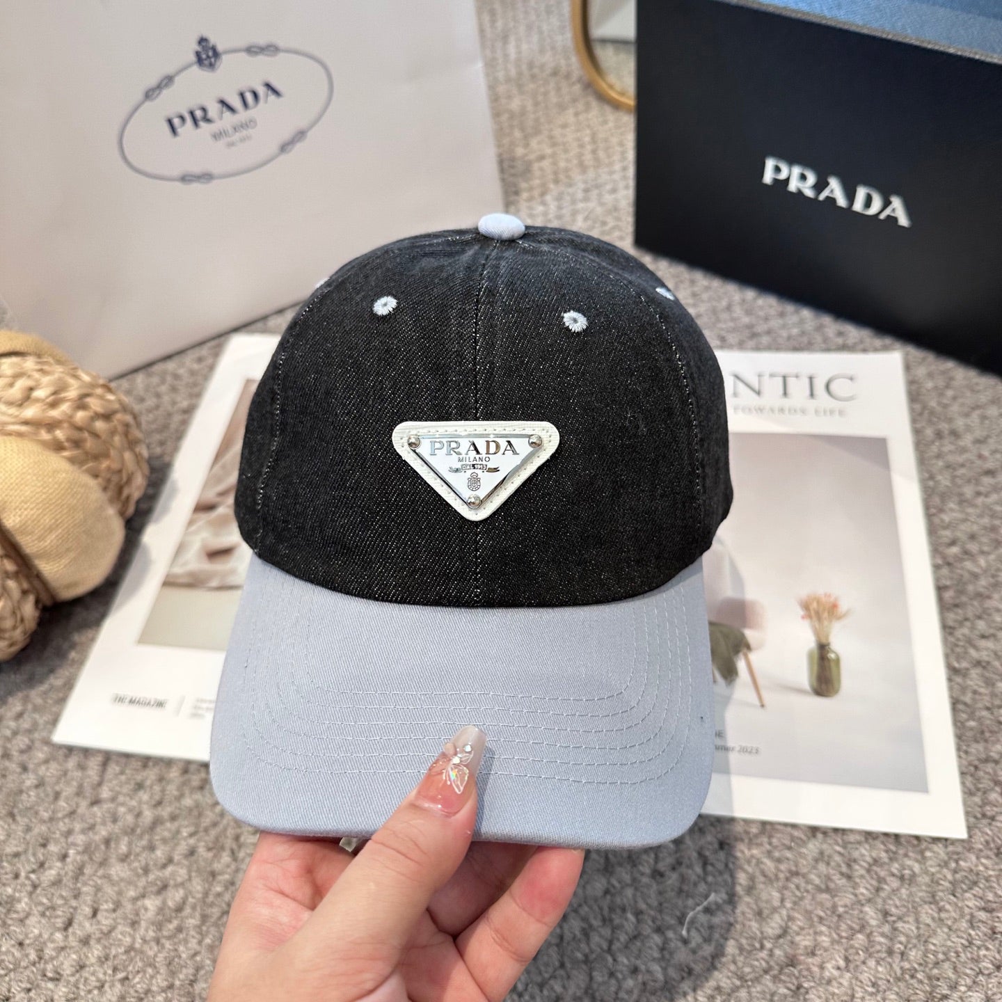 A two-tone denim baseball cap featuring a white triangle emblem patch on the front, neutral brim.